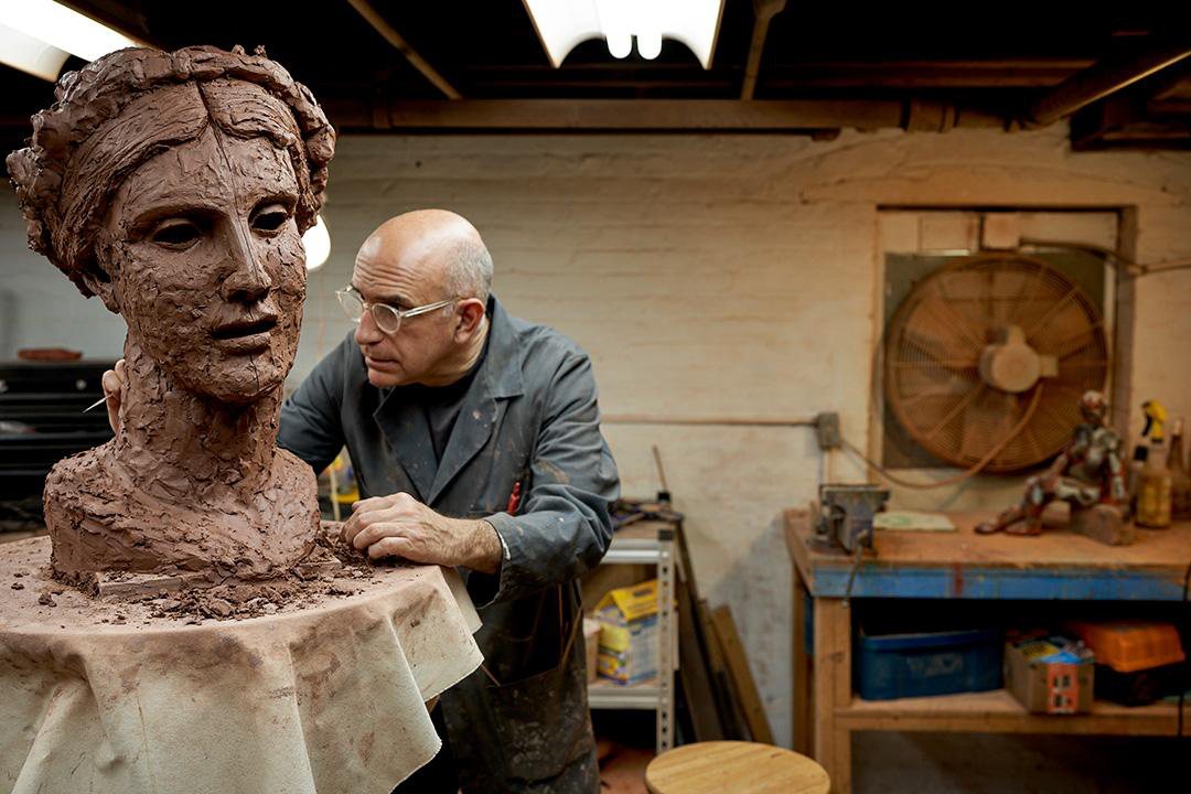 George Petrides modeling a portrait in clay